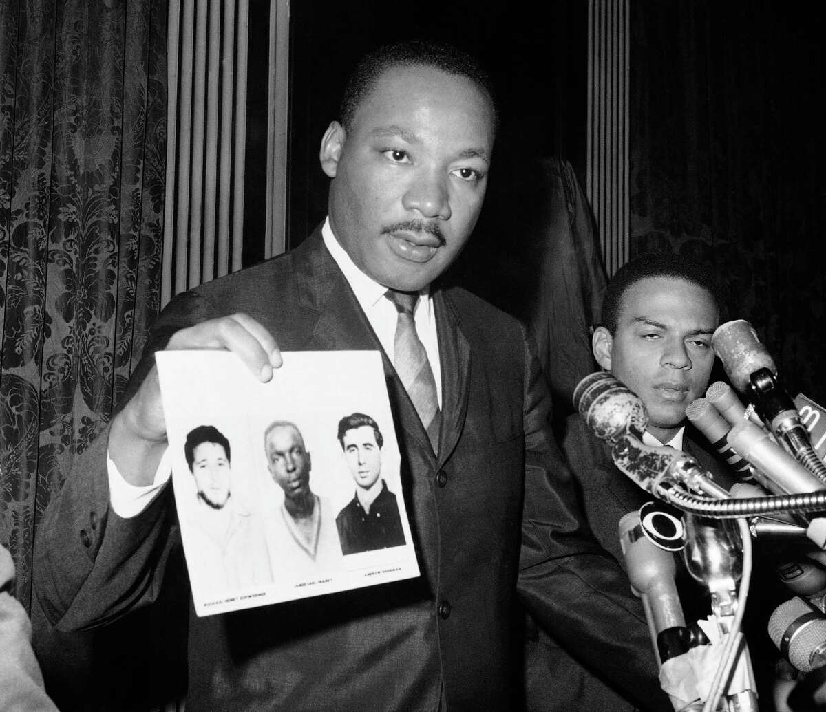 Martin Luther King Jr. holds up the photos of murdered civil rights workers Michael Schwerner, James Chaney, and Andrew Goodman. They died fighting to expand the right to vote. Nearly 60 years later, voting rights are under assault.