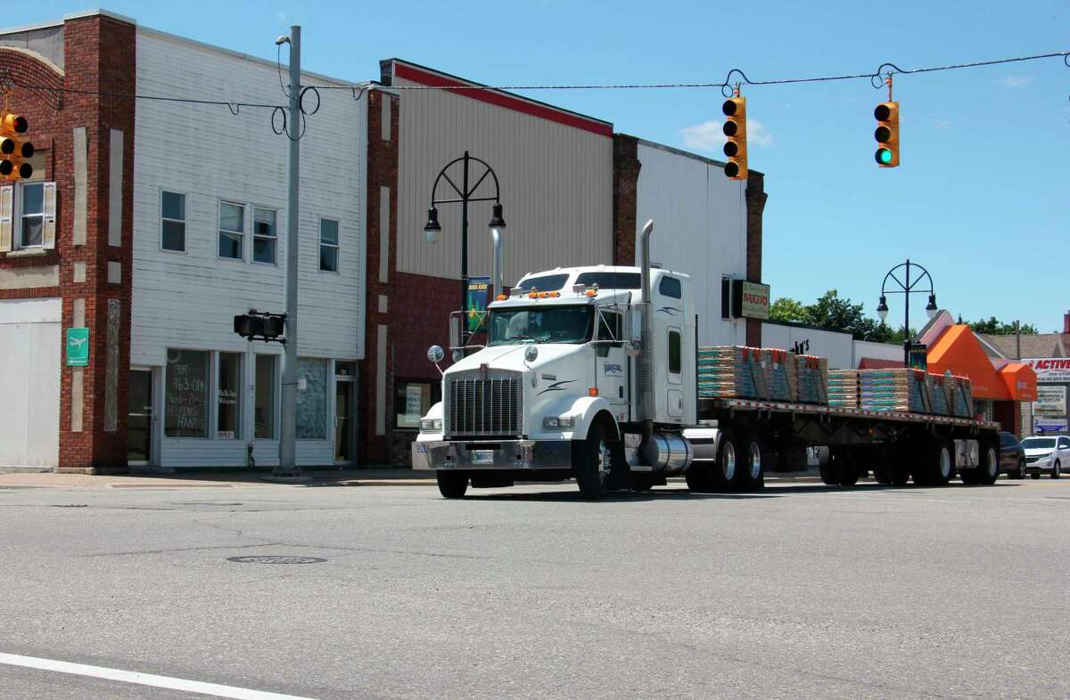 A truck crosses the intersection of Huron Avenue and Port Crescent Street in Bad Axe on a sunny afternoon July 21. (Teresa Homsi/Huron Daily Tribune)