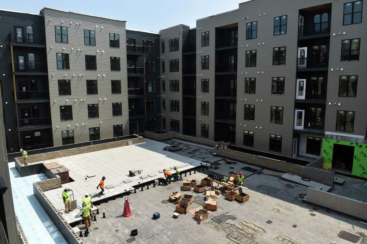 Pavers are installed in the Sports Courtyard of the Olive & Wooster Apartments in New Haven on July 22, 2021.