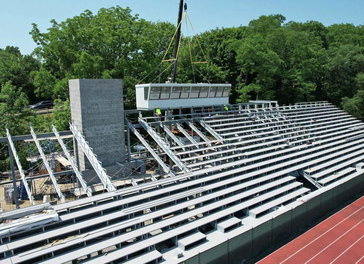The new press box is lowered on to the Cardinal Stadium bleachers at Greenwich High School in Greenwich, Conn. Tuesday, June 29, 2021. According to the district, the project to renovate the stadium is making good progress and the first phase of the project, which includes the home-side bleachers, could be complete sometime this fall.