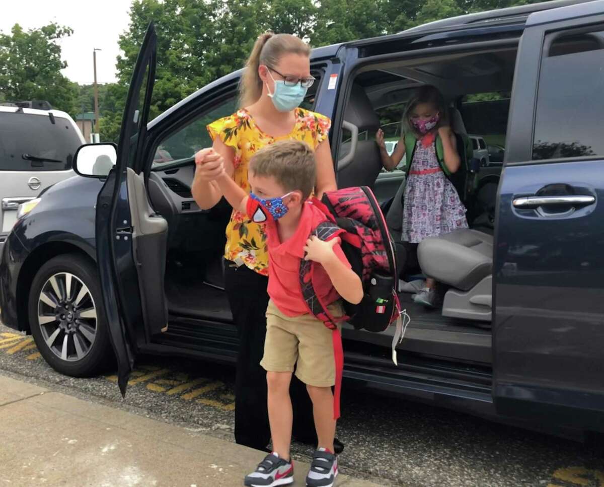 Courtney Kennedy helps her children, twins Owen and Teagan out of the car for their first day as first graders at Northville Elementary School on Sept. 8, 2020. The school year will start on time this Wednesday.