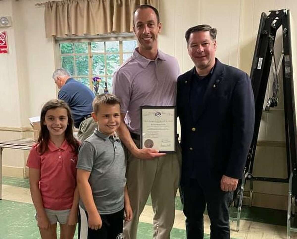 Robert Kozlowsky shows off his Distinguished Citizenship of the Year Award, which he received from the Bridgeport Elks Lodge 36 and the Grand Lodge, Benevolent Protective Order of Elks. Pictured with Kozlowsky are his children Regan and Kenneth, and Elks' Exalted Ruler William Russell