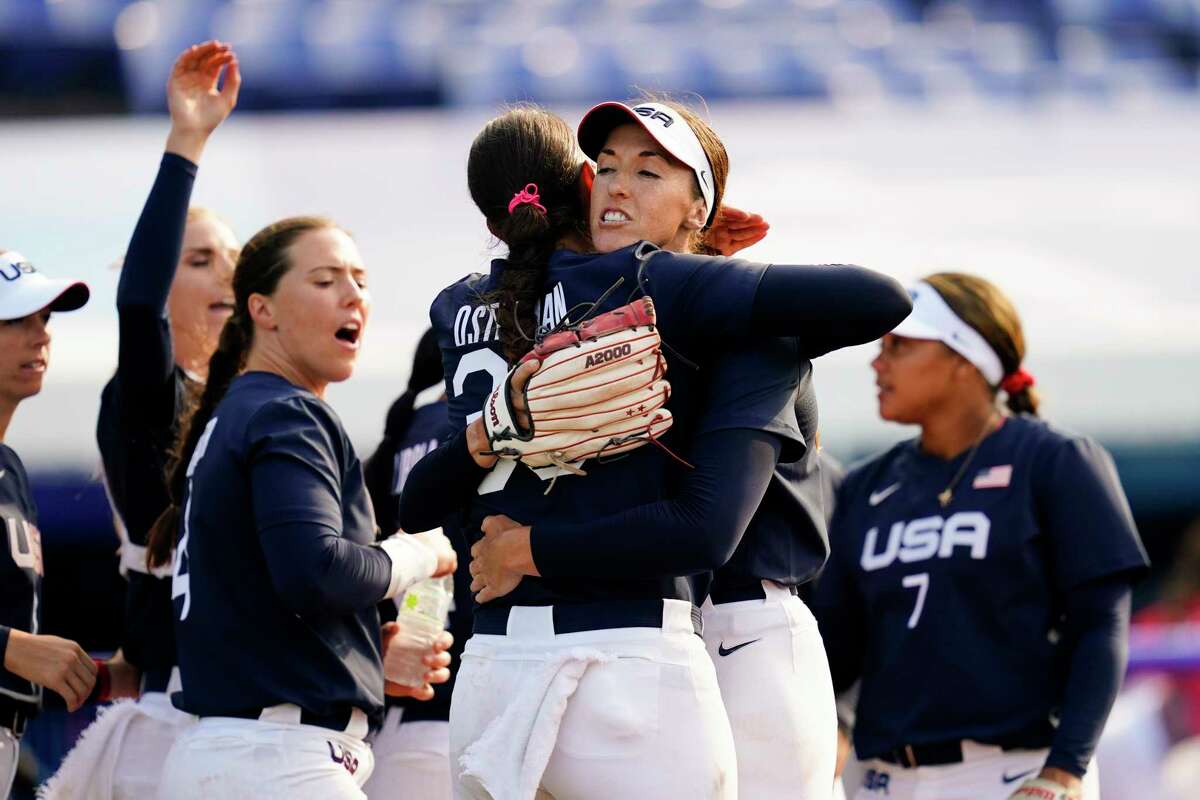 United States' Monica Abbott, center right, and Cat Osterman, center left, embrace defeating Mexico during a softball game at the 2020 Summer Olympics, Saturday, July 24, 2021, in Yokohama, Japan. (AP Photo/Matt Slocum)
