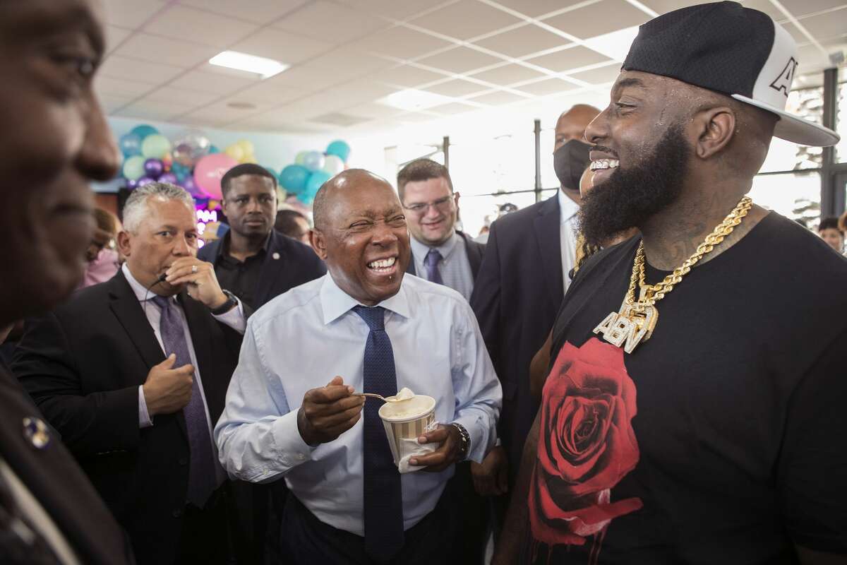 Mayor Sylvester Turner enjoys some ice cream with rap artist Trae the Truth during the grand opening of Howdy Homemade Ice Cream Thursday, July 22, 2021 in Katy.