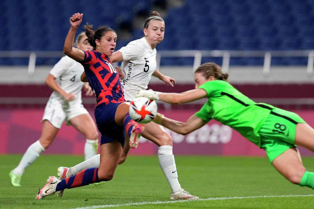 New Zealand's goalkeeper Anna Leat (18) makes a save against United States' Carli Lloyd (10) during a women's soccer match at the 2020 Summer Olympics, Saturday, July 24, 2021, in Saitama, Japan. (AP Photo/Martin Mejia)