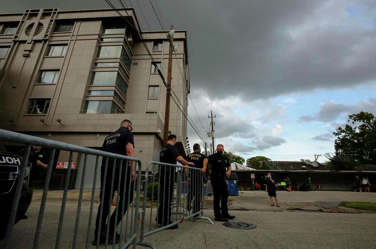 Houston Fire Department firefighters exit the scene at the Consulate General of China building Friday, July 24, 2020, in Houston. On Tuesday, the U.S. ordered the Houston consulate closed within 72 hours, alleging that Chinese agents had tried to steal data from facilities in Texas, including the Texas A&M medical system and The University of Texas MD Anderson Cancer Center in Houston.