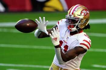 Santa Clara, California, USA. 18th Oct, 2020. San Francisco 49ers wide  receiver Brandon Aiyuk (11) celebrates touchdown with team member in front  of TV screen on Sunday, October 18, 2020, at Levis