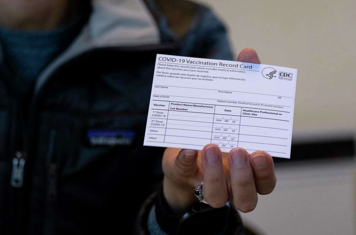 Sarah Gonzalez of New York, a nurse practitioner, displays a COVID-19 vaccine card at a New York Health and Hospitals vaccine clinic in the Brooklyn borough of New York on Jan. 10, 2021.
