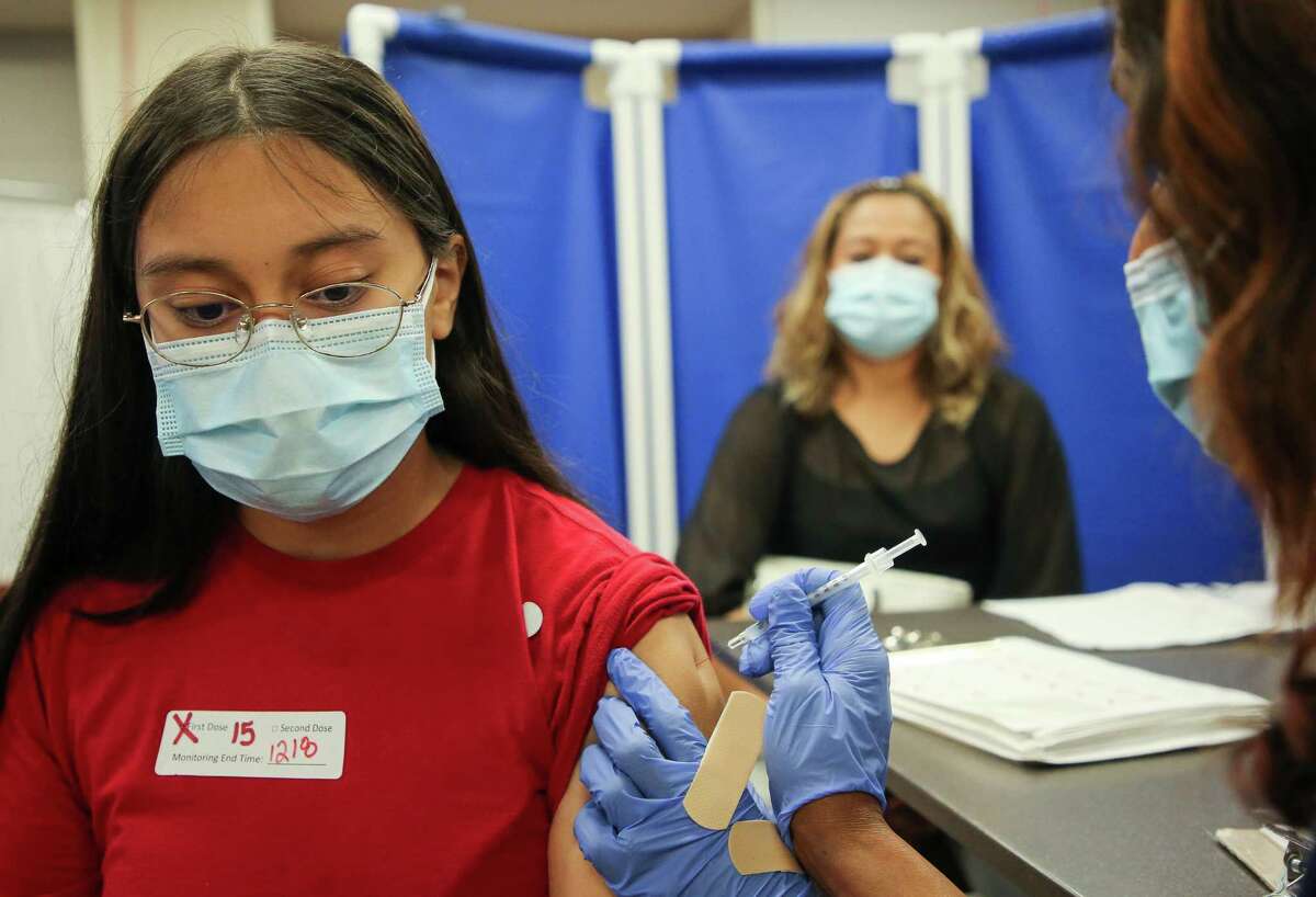 Fourteen-year-old Emilia López, left, received her first dose of the Pfizer COVID-19 vaccine at Houston Methodist Sugar Land Hospital on Thursday, July 22, 2021, in Sugar Land. Fort Bend County’s vaccination rate ranks among the highest in the state, although vaccinations have slowed as demand has dropped. The county is currently trying to reach the unvaccinated through community outreach, but critics say a $345,000 federally-funded program is a waste of money. Supporters say outreach remains important because some people lack access, information or the opportunity to get the vaccine still.
