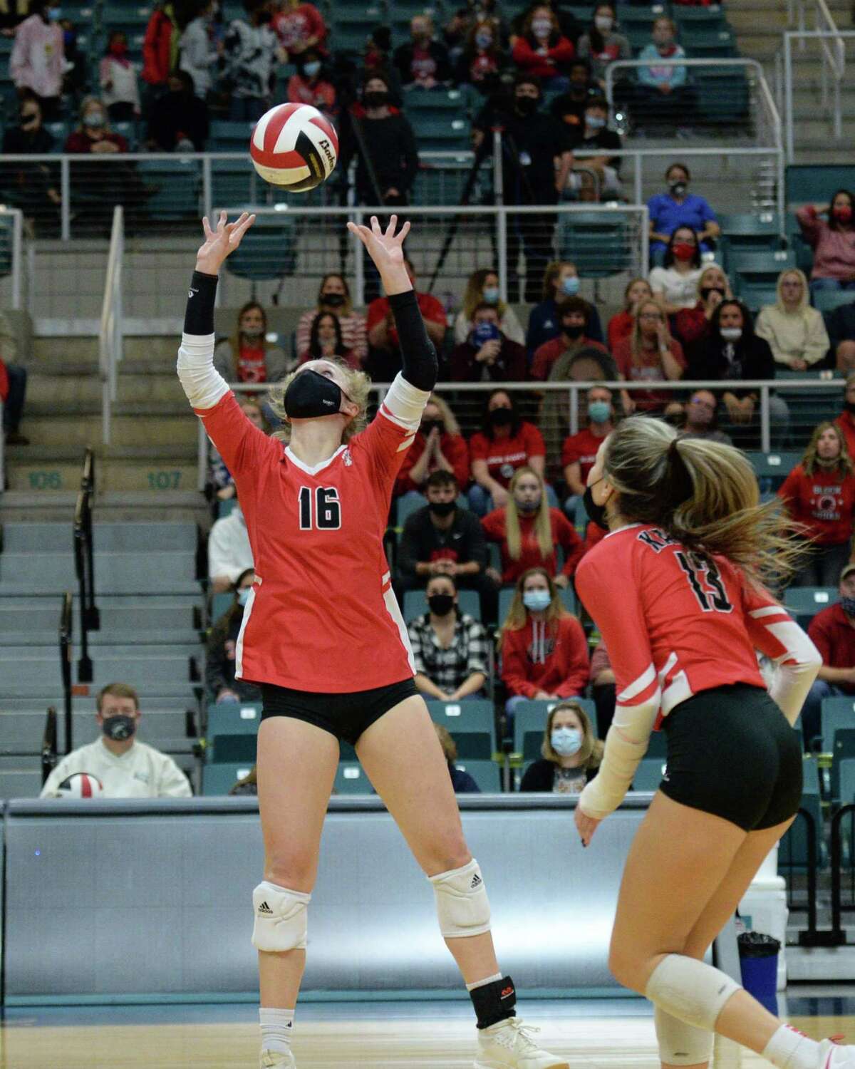 Maddie Waak (16) of Katy sets a ball for Reghan Jones (13) during the first set of the 6A Region 3 Championship game between the Katy Tigers and the Seven Lakes Spartans on Friday, December 4, 2020 at Leonard Merrell Center, Katy, TX.
