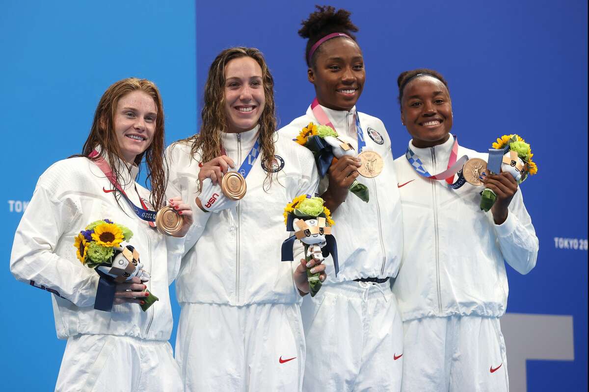 (L-R) Erika Brown, Abbey Weitzeil, Natalie Hinds and Simone Manuel of Team United States pose with the bronze medal for the Women's 4 x 100m Freestyle Relay Final on day two of the Tokyo 2020 Olympic Games at Tokyo Aquatics Centre on July 25, 2021 in Tokyo, Japan. (Photo by Clive Rose/Getty Images)