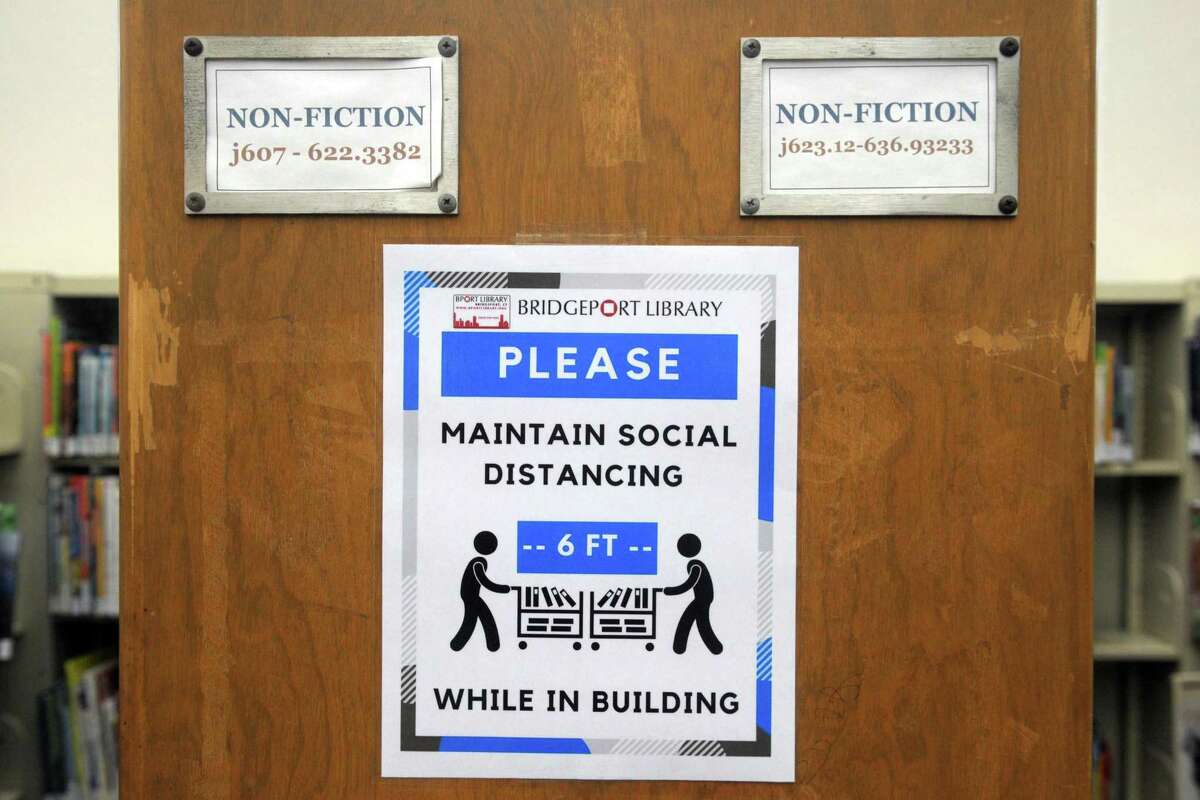 Safety and social distancing reminders in place in the Burroughs-Saden branch library in downtown Bridgeport.