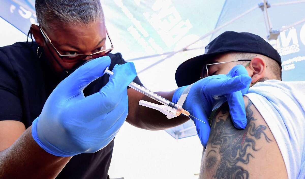 Nurse Eon Walk administers the Pfizer COVID-19 vaccine at a mobile vaccine clinic in Los Angeles on July 16, 2021.