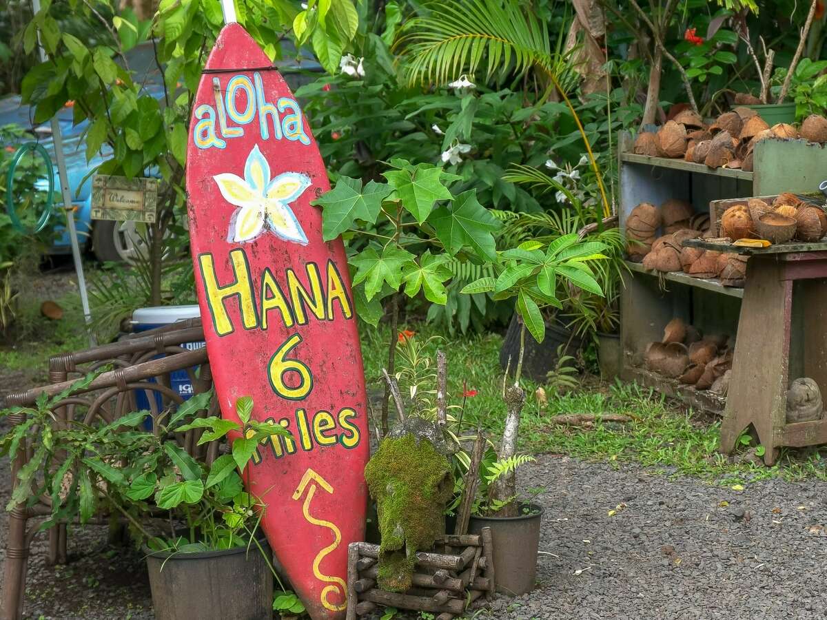 An old surfboard has been repurposed as a road sign along Maui's Road to Hana. 