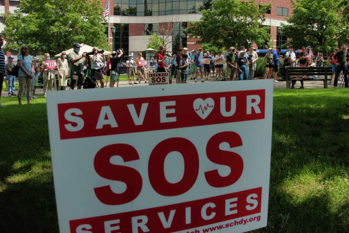 A coalition of advocates who oppose an ongoing merger between Schenectady's Ellis Medicine and St. Peter's Health Partners has launched an online survey. Pictured are people gathered for the SOS: Save Our Services Rally at Veteran's Park on Sunday, July 25, 2021, in Schenectady, N.Y. They said they have concerns about the loss of services that may result from the merger of Ellis Medicine and St. Peter's Health Partners, which is owned by Trinity Health, a national Catholic health system.