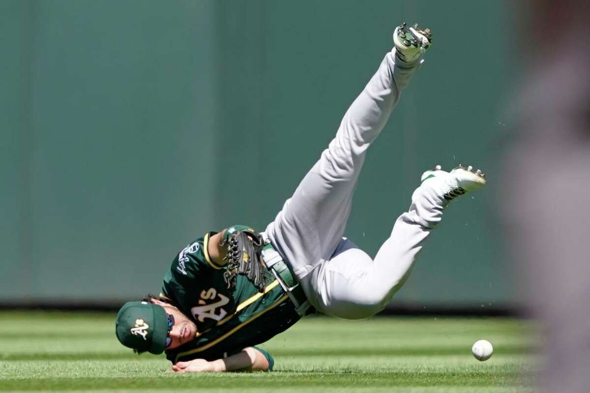 Oakland Athletics center fielder Ramon Laureano dives but can't get to an RBI single hit by Seattle Mariners' Tom Murphy during the third inning of a baseball game, Sunday, July 25, 2021, in Seattle. (AP Photo/Ted S. Warren)