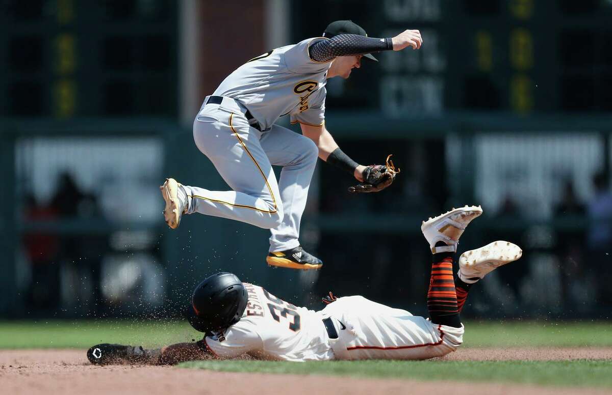 Thairo Estrada of the Giants steals second base as Kevin Newman of the Pirates is unable to catch the throw from the catcher, allowing Steven Duggar to score in the bottom of the sixth.