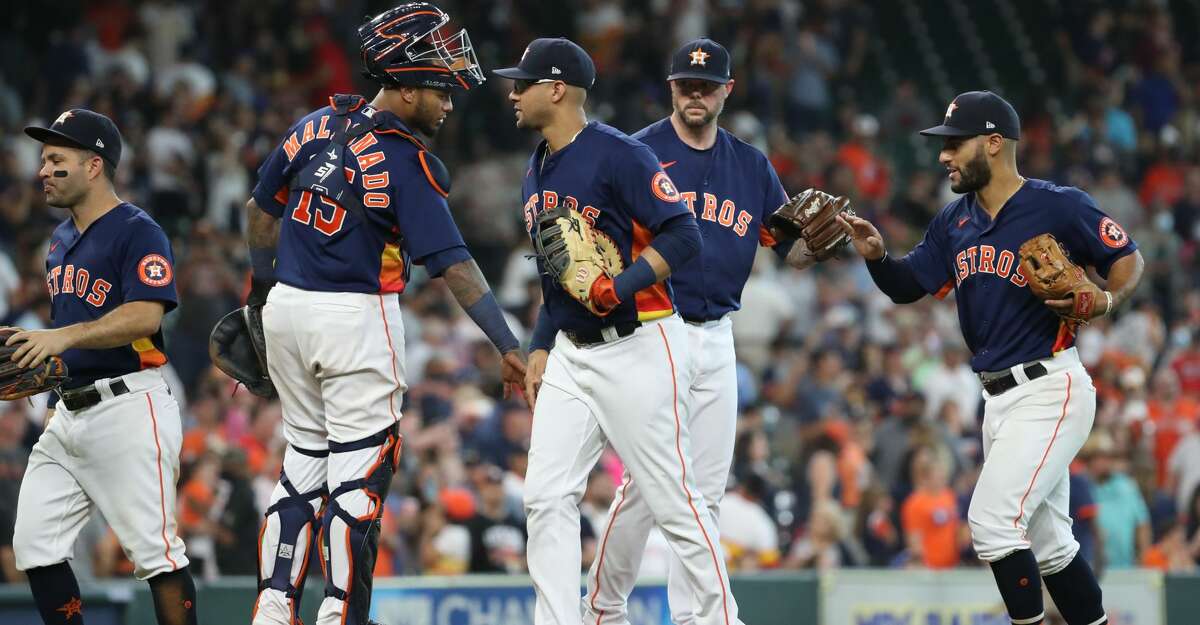 Houston Astros celebrate after beating the Texas Rangers on Sunday, July 25, 2021, at Minute Maid Park in Houston.