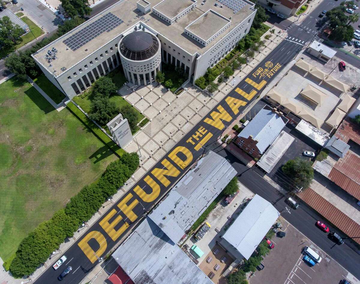 Giant, yellow letters, seen Aug. 18, 2020, painted on Victoria Street in front of the federal courthouse in Laredo.