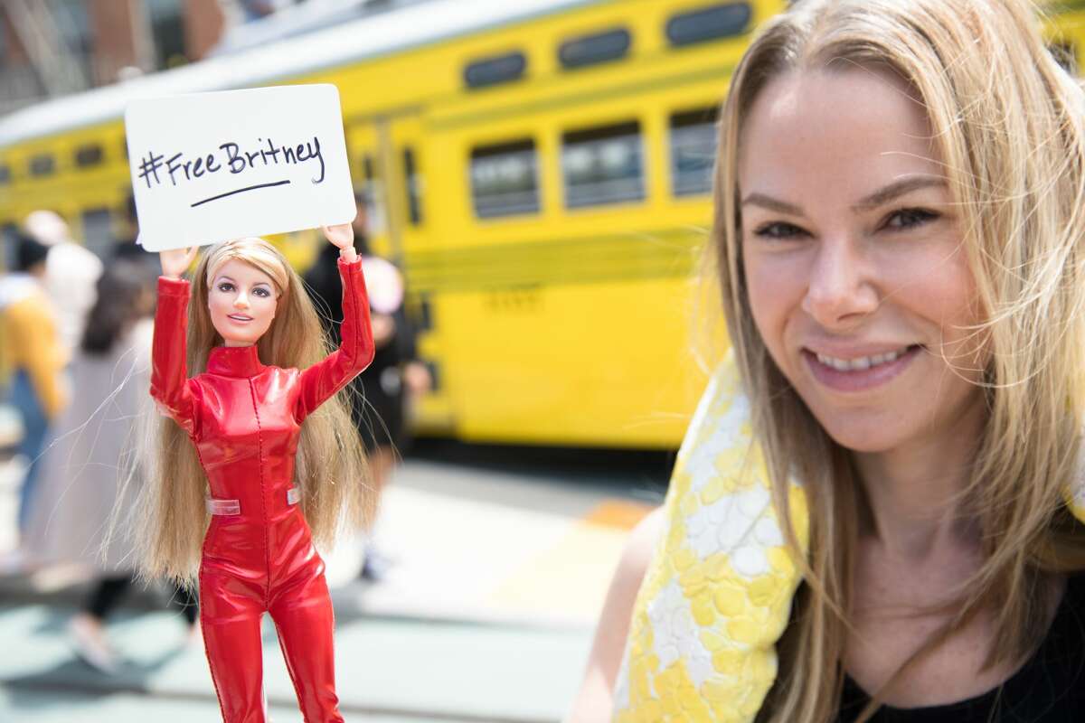 Jamie Legasa holds up a Britney Spears doll with a sign with the hashtag #FreeBritney.  Free Britney supporters held a rally on Market and Castro streets in San Francisco on July 25, 2021.  The Free Britney Movement seeks to end Britney Spears Conservatories and raise awareness of Conservatory abuse.