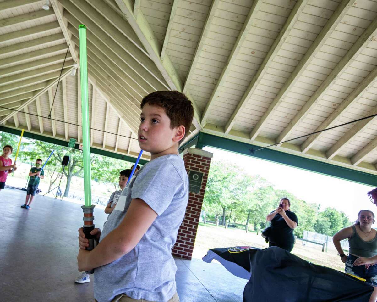 Sebastian Oliveria, 9, stands at the ready with his lightsaber during Jedi training held by the Shelton Library System on Saturday, July 24, 2021.