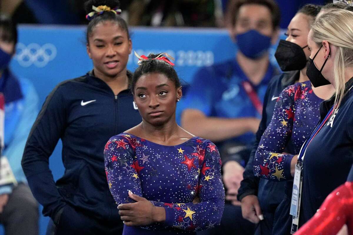 Simone Biles, of the United States, waits for her score after performing on the balance beam during the women's artistic gymnastic qualifications at the 2020 Summer Olympics, Sunday, July 25, 2021, in Tokyo.