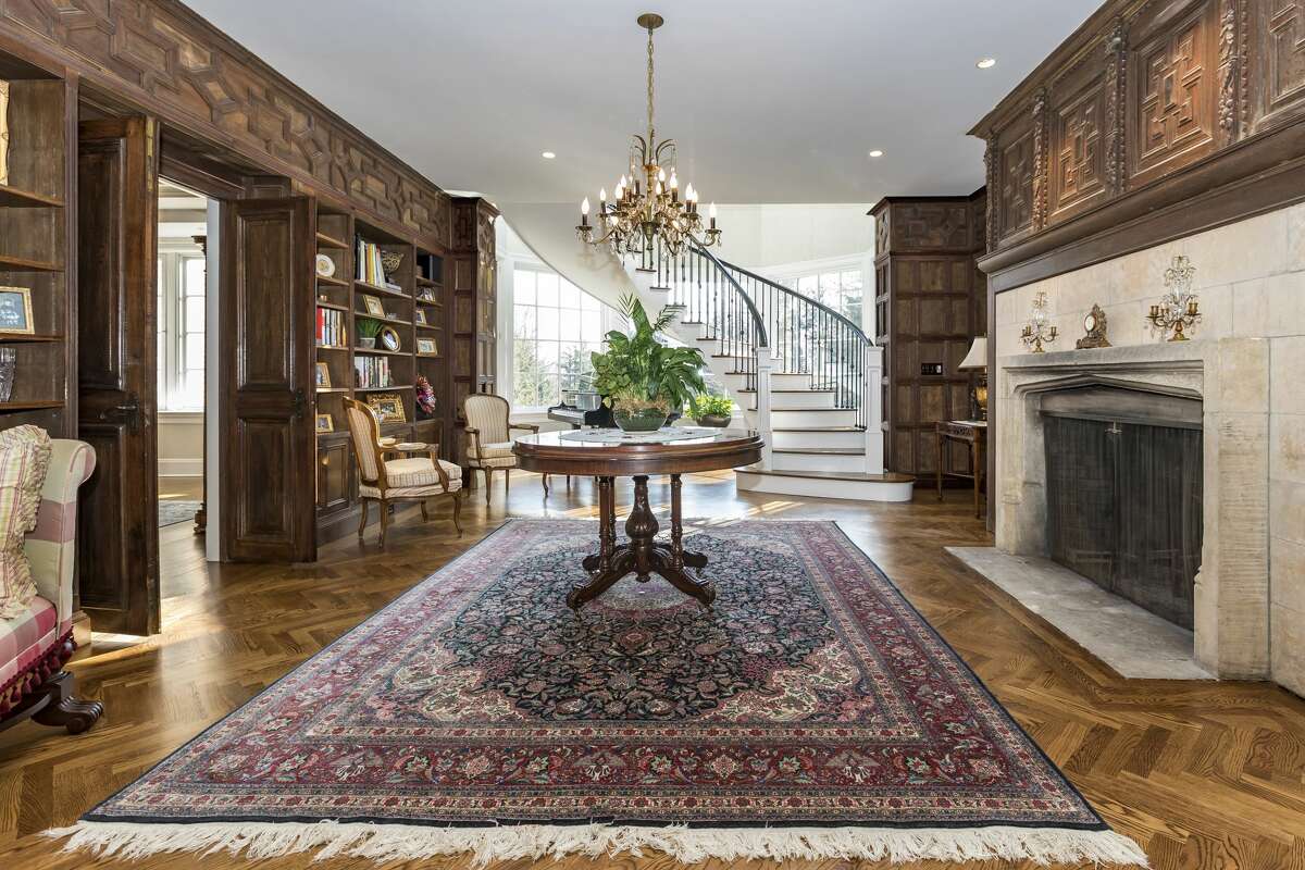 The drawing room in the home on 17 Rippowam Road in Ridgefield, Conn. is paneled in wood from the Vanderbilt yacht in 1940s, according to the listing, and contains one of five fireplaces in the home. 