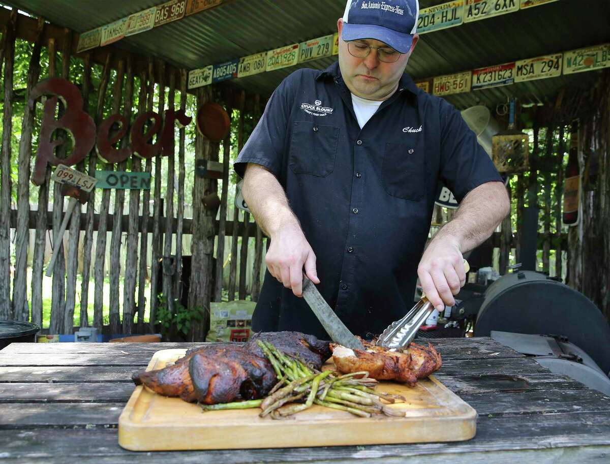 Chuck Blount takes chickens off the smoker and prepares for a taste test of the three options.