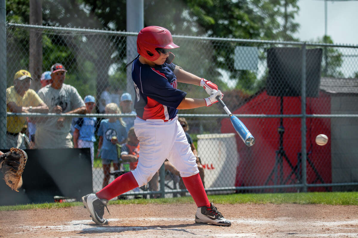 Midland Fraternal Northwest's Bradyn Robinson pounds the ball through the gap and into the outfield during a game against Greater Bay in the Little League 11U state tournament Monday, July 26, 2021 at the Bay City Northwest ball complex. (Drew Travis/for the Daily News)