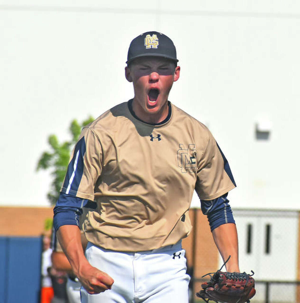 Father McGivney starting pitcher Jackson Rodgers reacts after striking out three straight to end the first inning against Greenfield.