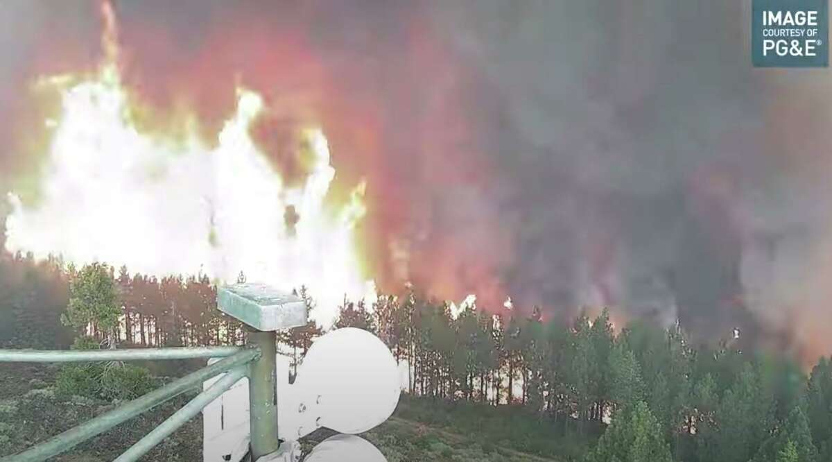 In this video frame grab, the remote wildfire camera at Indian Ridge in the Sierra near Lake Almanor captures flames from the Dixie Fire that will soon engulf it on Saturday, July 24, 2021.
