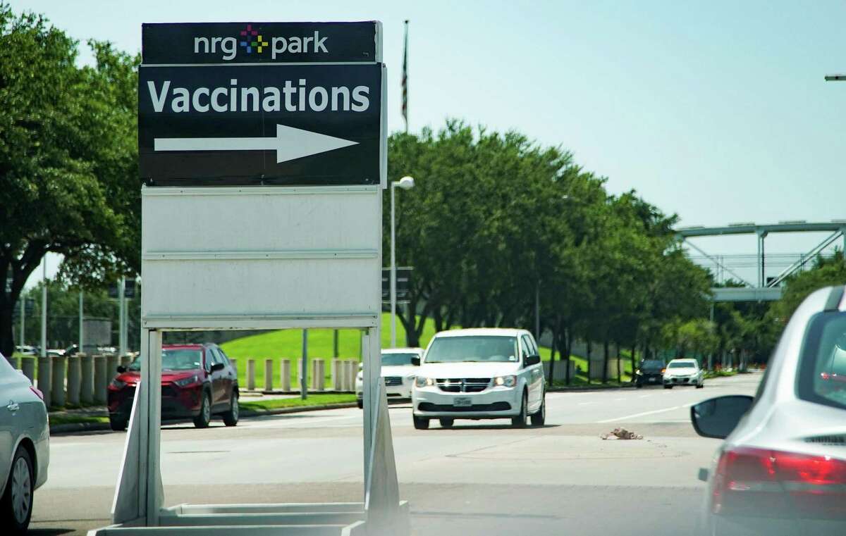 Signs for Harris County Health Dept., mass vaccination site at NRG in July.