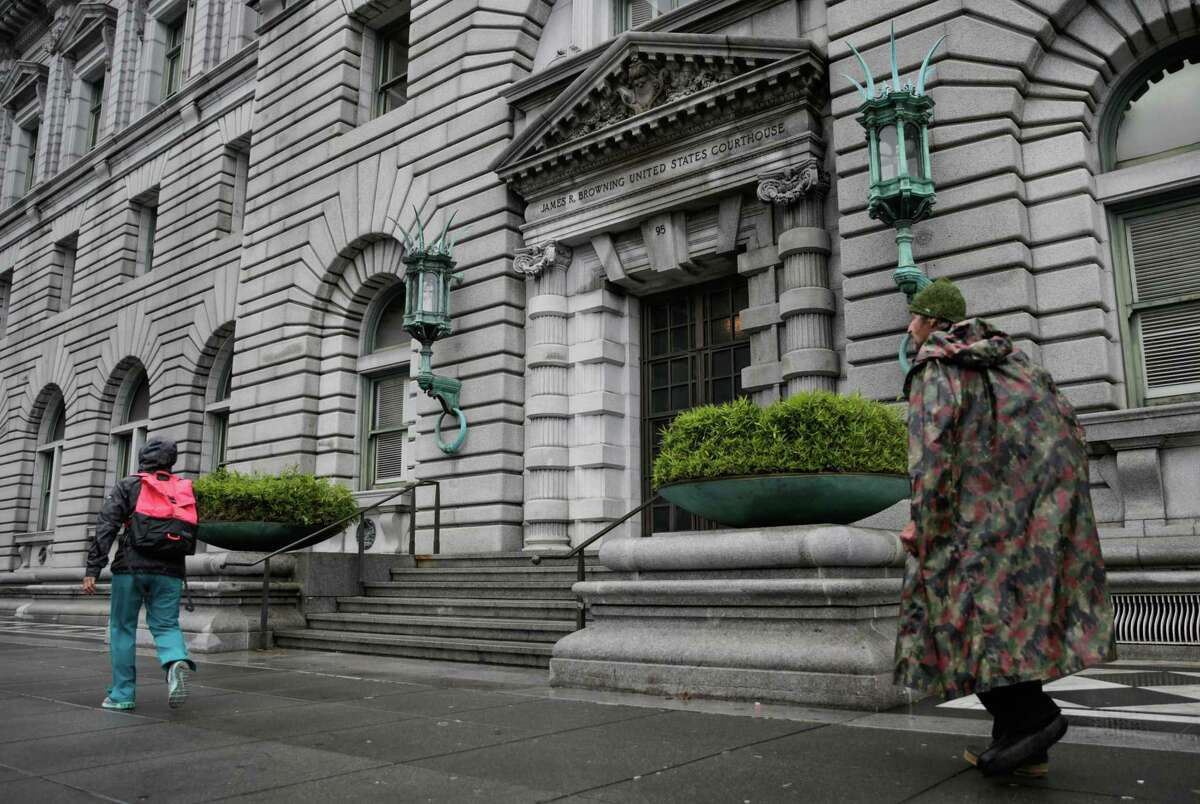 Pedestrians walk past the Ninth U.S. Circuit Court of Appeals building in San Francisco.