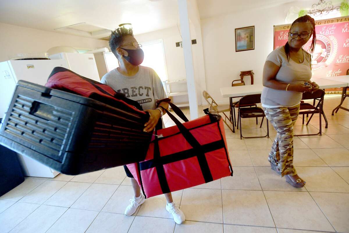 Judith Lewis (right) talks with Summer Food program delivery driver Ferry Griffin as she drops off the day's delivery during the Summer Meals program at St. Luke Missionary Baptist Church Monday. Photo made Monday, July 26, 2021 Kim Brent/The Enterprise