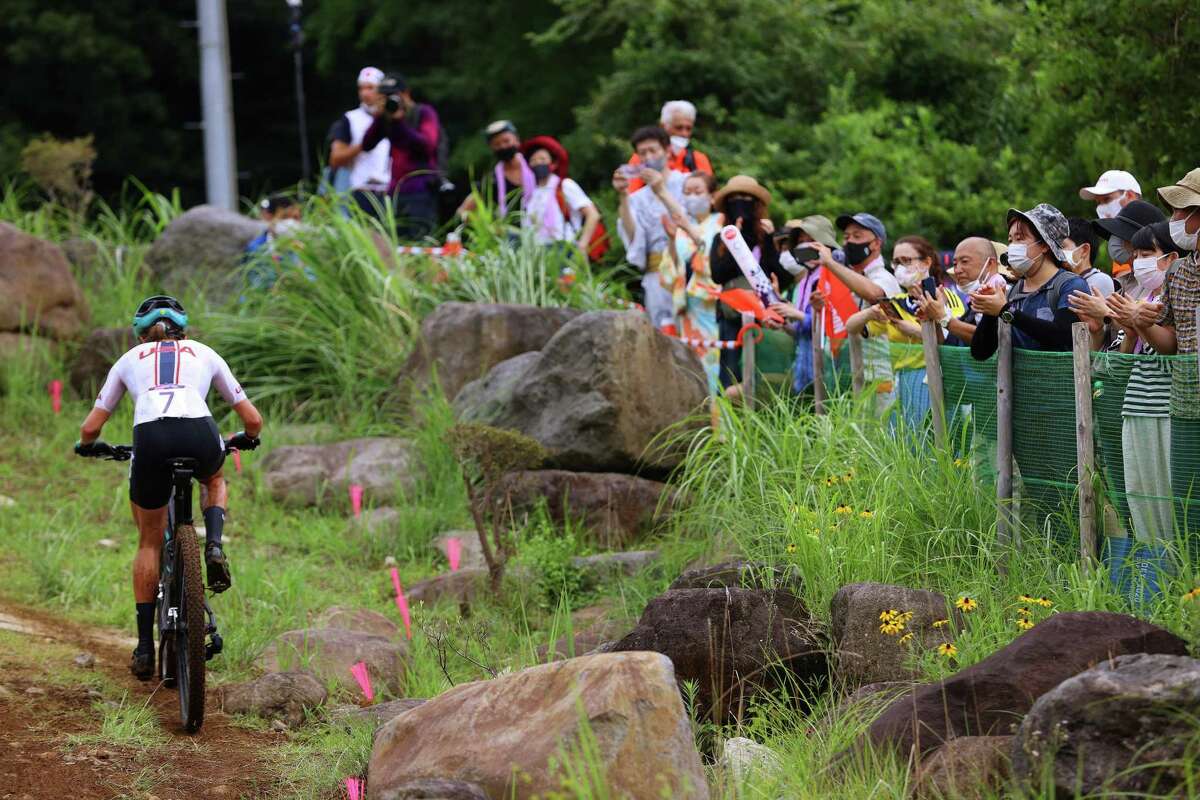 IZU, JAPAN - JULY 27: Kate Courtney of Team United States rides while fans watch during the Women's Cross-country race on day four of the Tokyo 2020 Olympic Games at Izu Mountain Bike Course on July 27, 2021 in Izu, Shizuoka, Japan. (Photo by Tim de Waele/Getty Images)