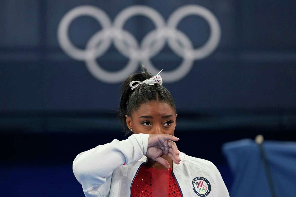 Simone Biles, of the United States, watches gymnasts perform after an apparent injury, at the 2020 Summer Olympics, Tuesday, July 27, 2021, in Tokyo. Biles withdrew from the team finals.