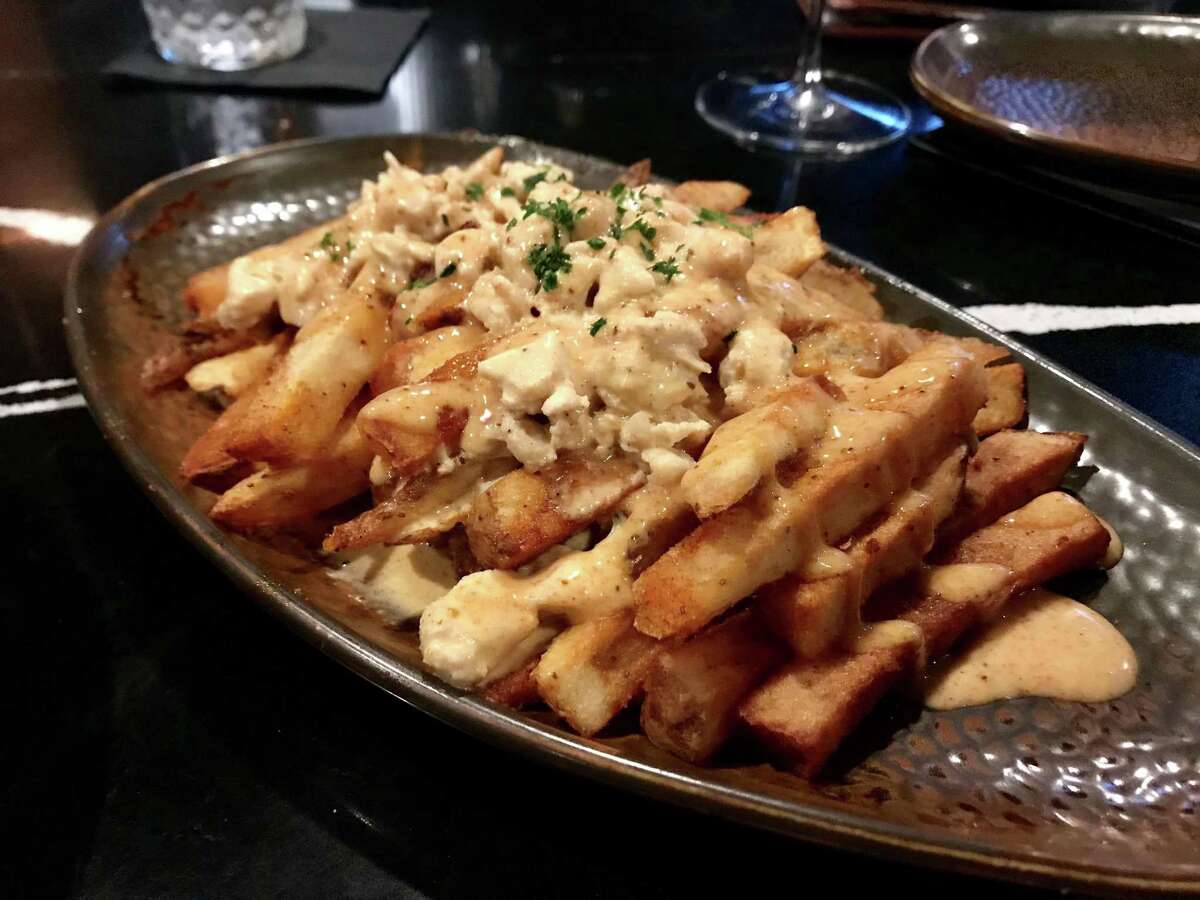 Loaded hand-cut fries with crab cream at Thirteen in Midtown