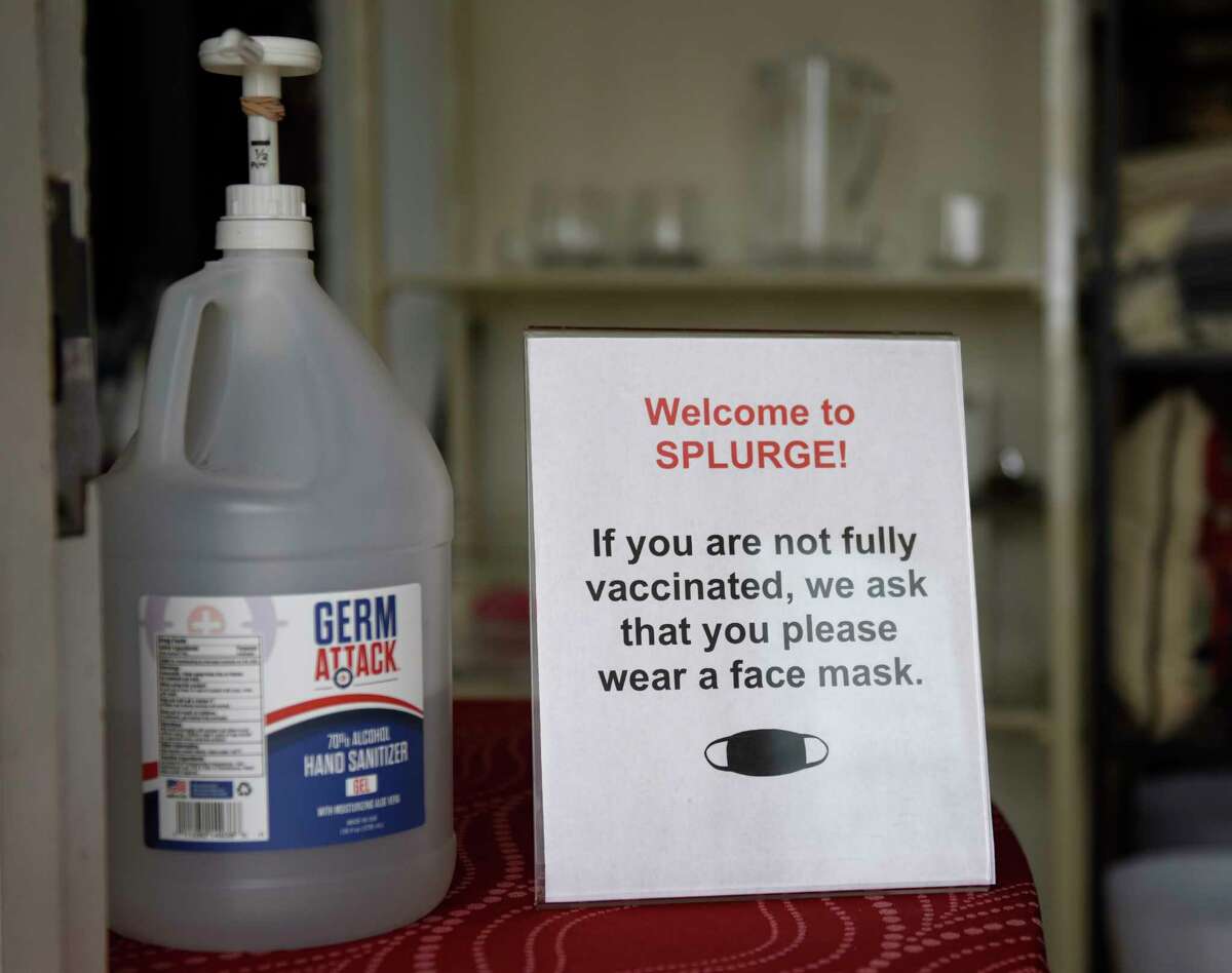 A sign requires mask usage for unvaccinated shoppers at Splurge in Greenwich, Conn. Tuesday, July 27, 2021.