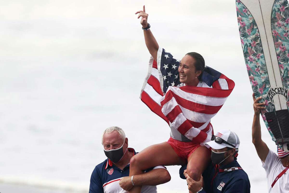 ICHINOMIYA, JAPAN - JULY 27: Carissa Moore of Team United States celebrates winning the Gold Medal after her final match against Bianca Buitendag of Team South Africa on day four of the Tokyo 2020 Olympic Games at Tsurigasaki Surfing Beach on July 27, 2021 in Ichinomiya, Chiba, Japan. (Photo by Ryan Pierse/Getty Images)