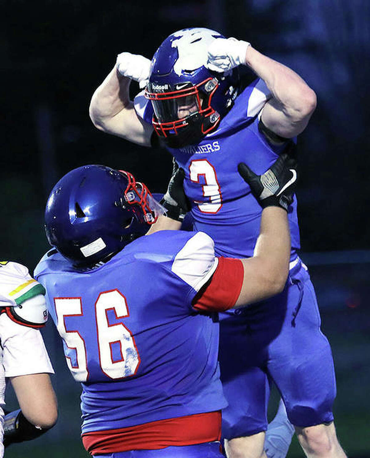 Carlinville’s Bobby Seal (3) is congratulated by teammate Ethan Trimm (56) after Seal scored one of his four TDs in a win over Southwestern last season in Carlinville.