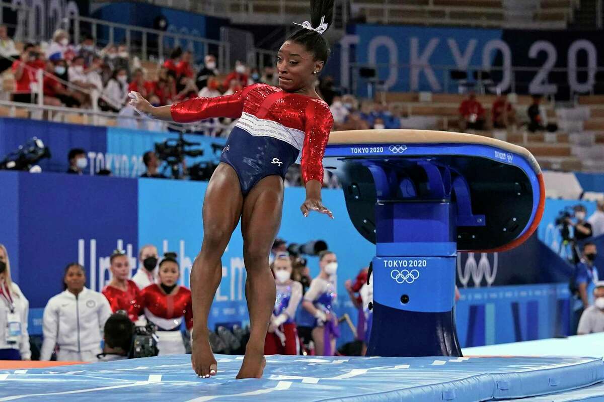 Simone Biles, of the United States, lands from the vault during the artistic gymnastics women's final at the 2020 Summer Olympics, Tuesday, July 27, 2021, in Tokyo. (AP Photo/Gregory Bull)