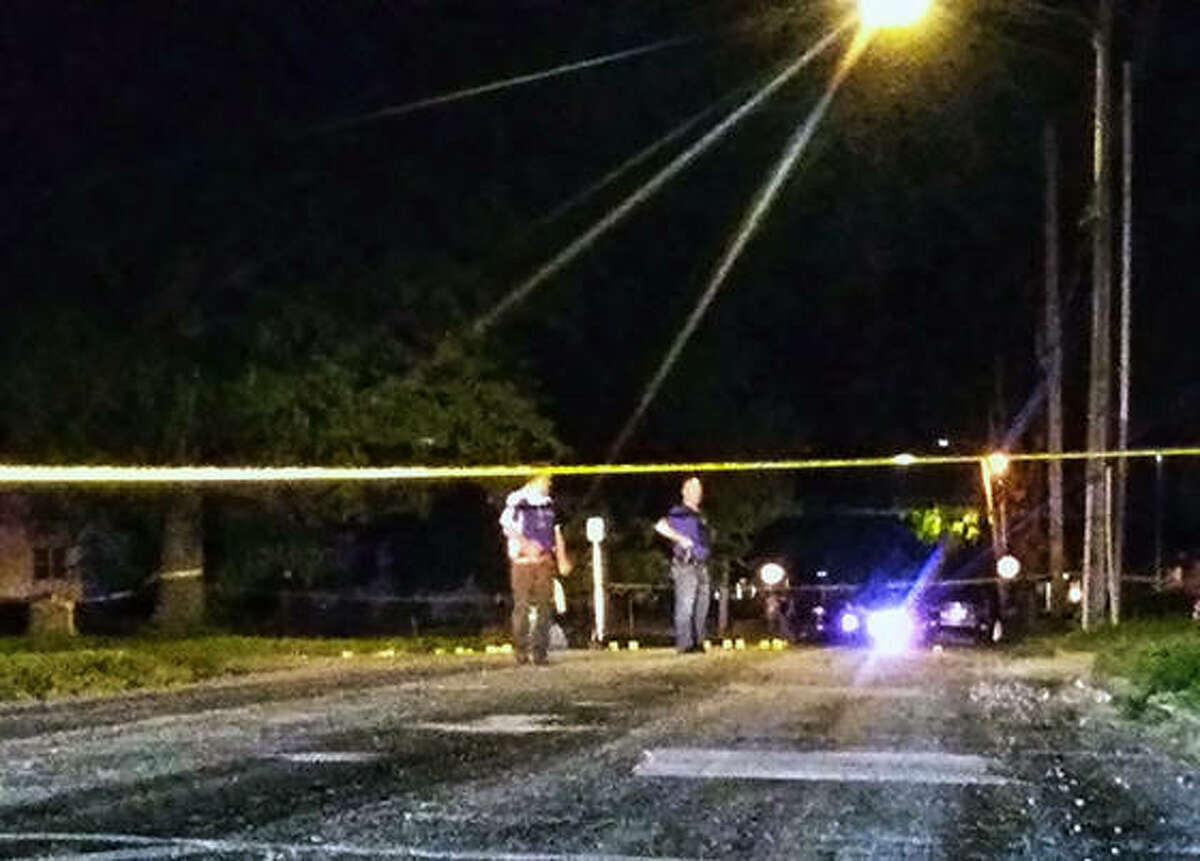 Jacksonville Police officers investigate the firing of 15 to 20 shots in the 600 block of Jordan Street on Tuesday night.