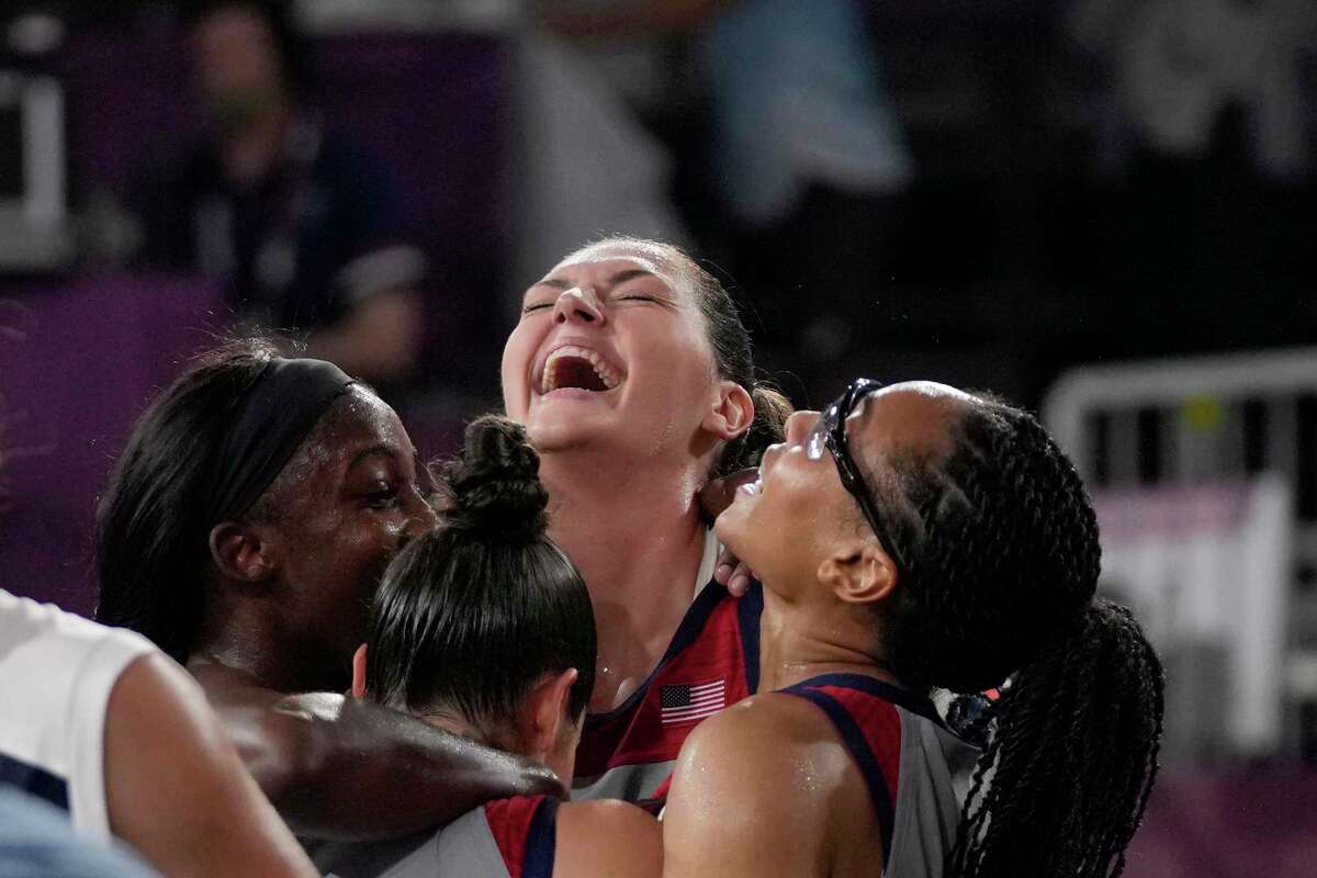 United States’ Stefanie Dolson, top, celebrates with teammates Jackie Young, left, Kelsey Plum and Allisha Gray, right, after defeating Russian Olympic Committee in a women’s 3-on-3 gold medal basketball game at the 2020 Summer Olympics, Wednesday, July 28, 2021, in Tokyo.