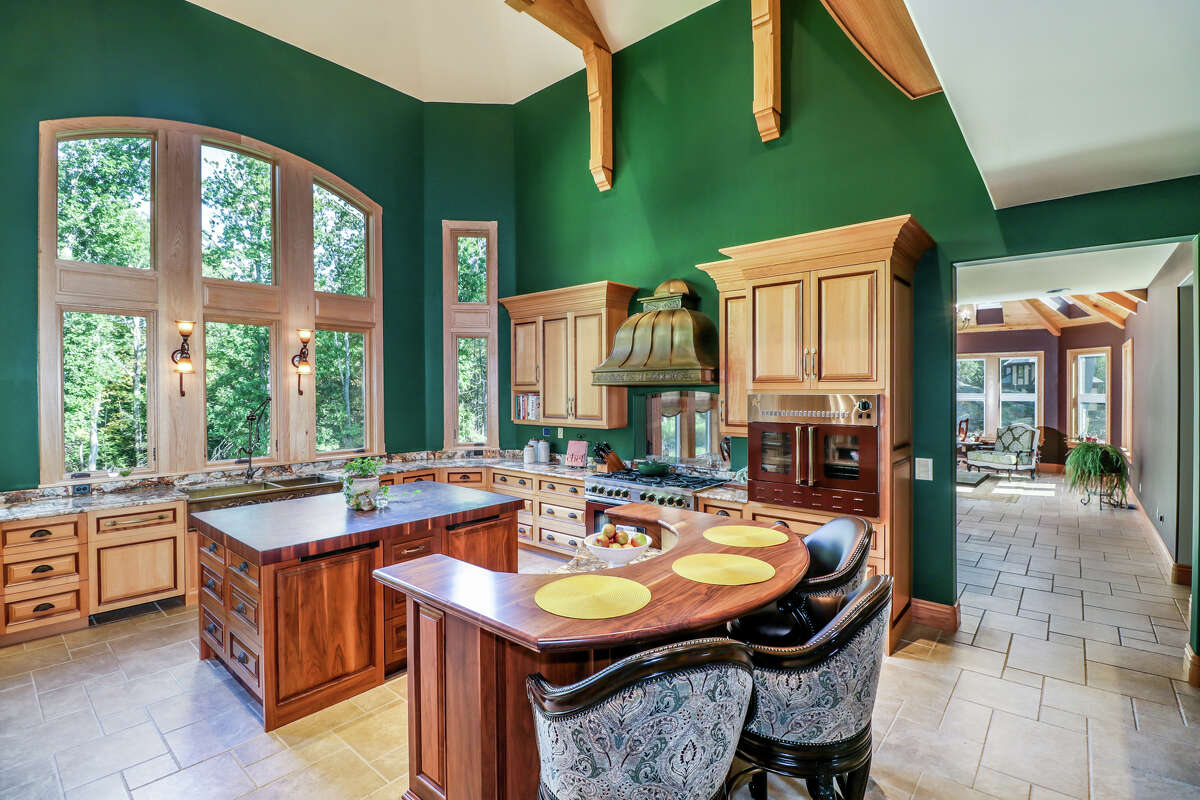 The kitchen has a custom bronze hood and a professional-grade range.  View listing