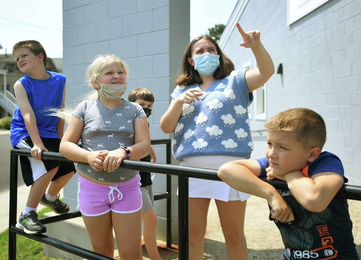 Recent meteorology graduate Veronica Piscitelli points out a variety of cloud types during the Milford Recreation Department's one week summer meteorology camp at the Tri Beach Center in Milford, Conn. on Tuesday, July 27, 2021. From left are Logan Lawless, 9, Remi Brenner, 9, Ian Bear, 9, Piscitelli, and Michaerl Pietrini, 6.
