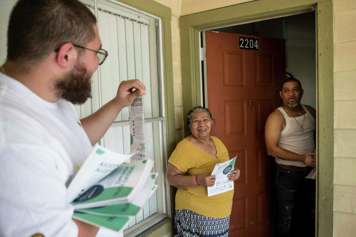 Luis Cadavid talks to Marcia Laguna and Felix Torres about the Houston-Harris County Emergency Rental Assistance Program Wednesday, June 30, 2021 in Houston. The city and county has $196 million to help renters avoid eviction. But many behind on rent have not heard of the fund, spurring the effort to reach out to people in the community.