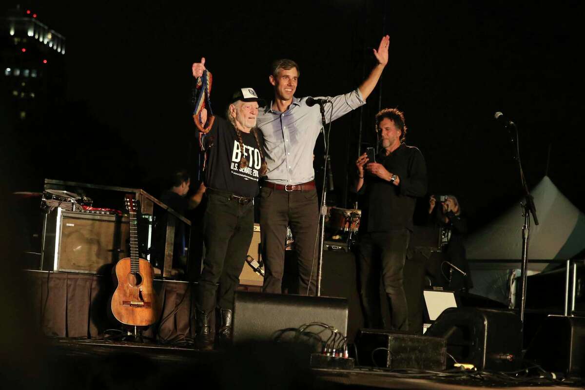 From left, artist Willie Nelson and Rep. Beto O'Rourke, D-Texas, wave to the crowd during the 2018 "Turn Out for Texas" concert and rally at Auditorium Shores in Austin, Texas. O'Rourke is again partnering with Nelson for a concert rally Sunday.
