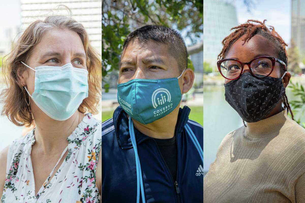 From left, Claire Ramsey, Hernan Morales and Njeri Karanja wear masks at Lake Merritt in Oakland on Wednesday. Many Bay Area residents support stronger masking recommendations.