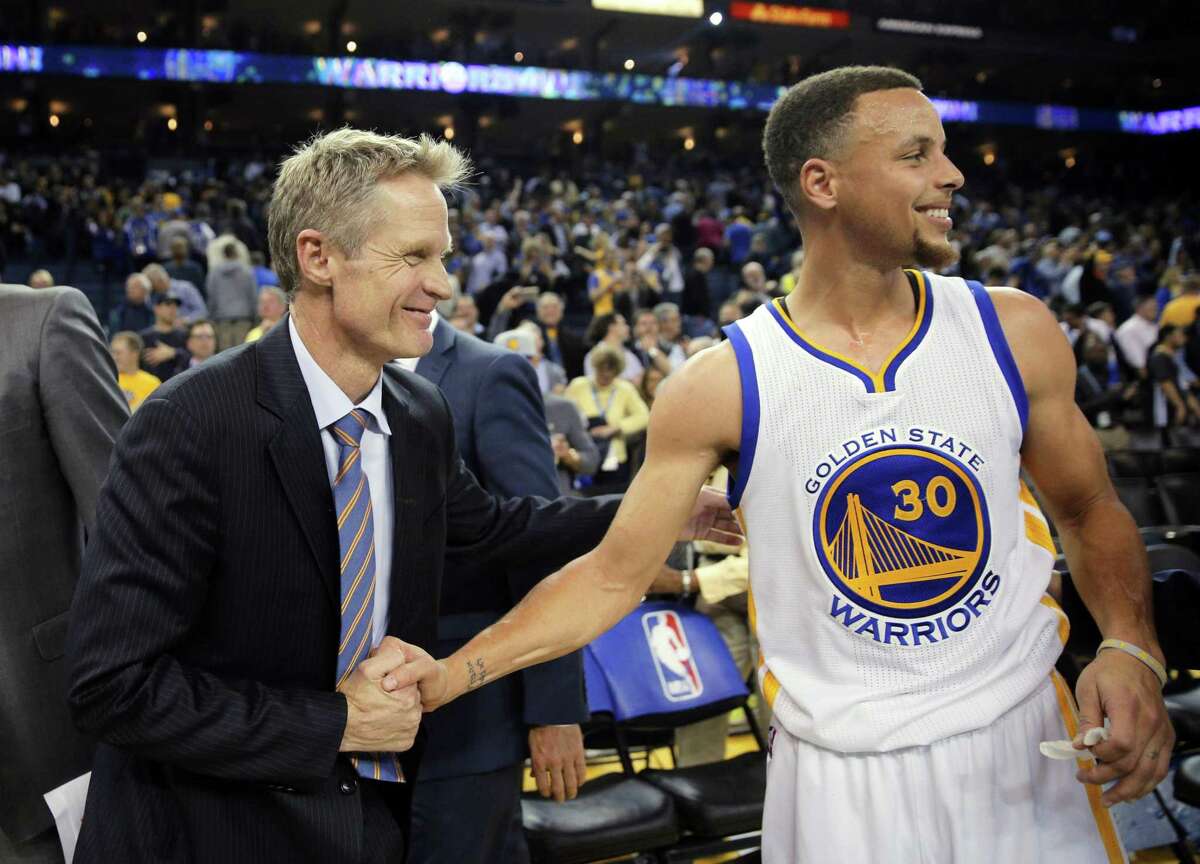 Steve Kerr and Stephen Curry (30) celebrate after the win as the Golden State Warriors played the Oklahoma City Thunder at Oracle Arena in Oakland, Calif., on Thursday, March 3, 2016. The Warriors defeated the Thunder 121-106 to tie the longest home winning streak at 44 games.