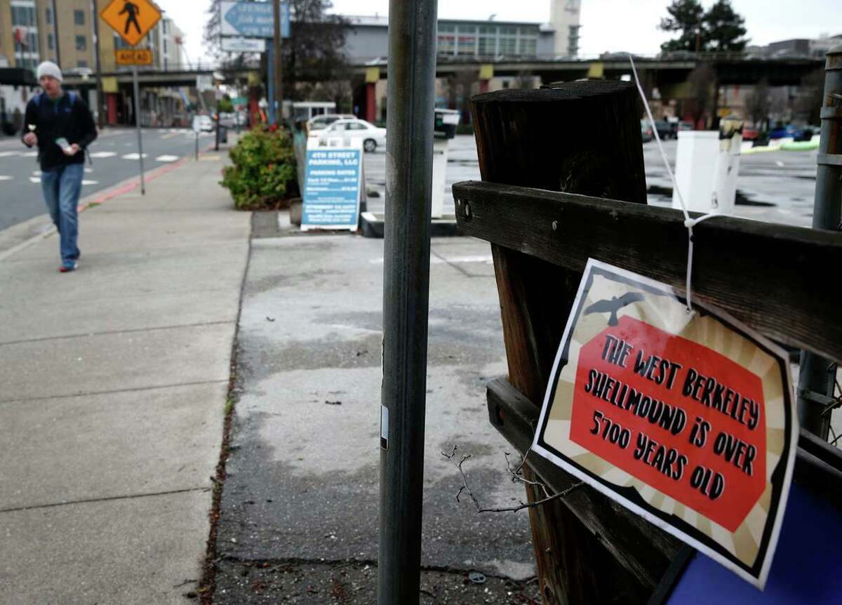 A sign describing the site’s historical significance hangs at a parking lot slated for development across from Spenger’s restaurant on Fourth Street in Berkeley. The state Supreme Court has allowed the housing and retail project to go forward.